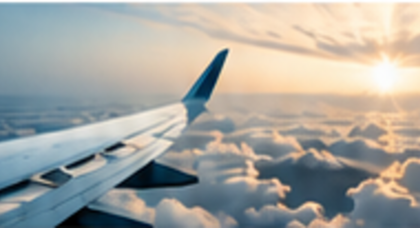 Airplane wing flying above the clouds